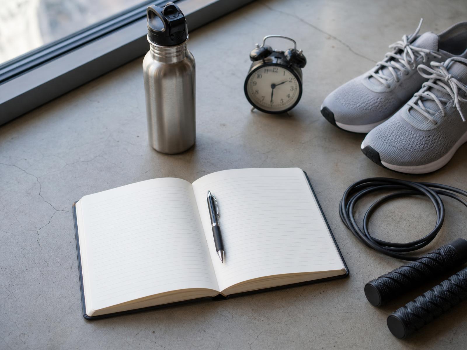 Journal, water bottle, jump rope and shoes laid out for a morning routine